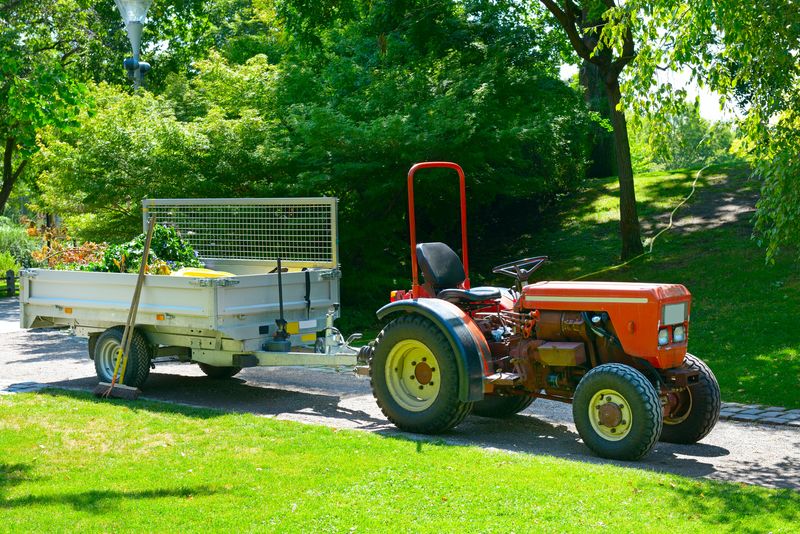 A tractor connected to a utility trailer.