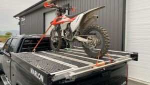A dirt bike on a Marlon truck bed.